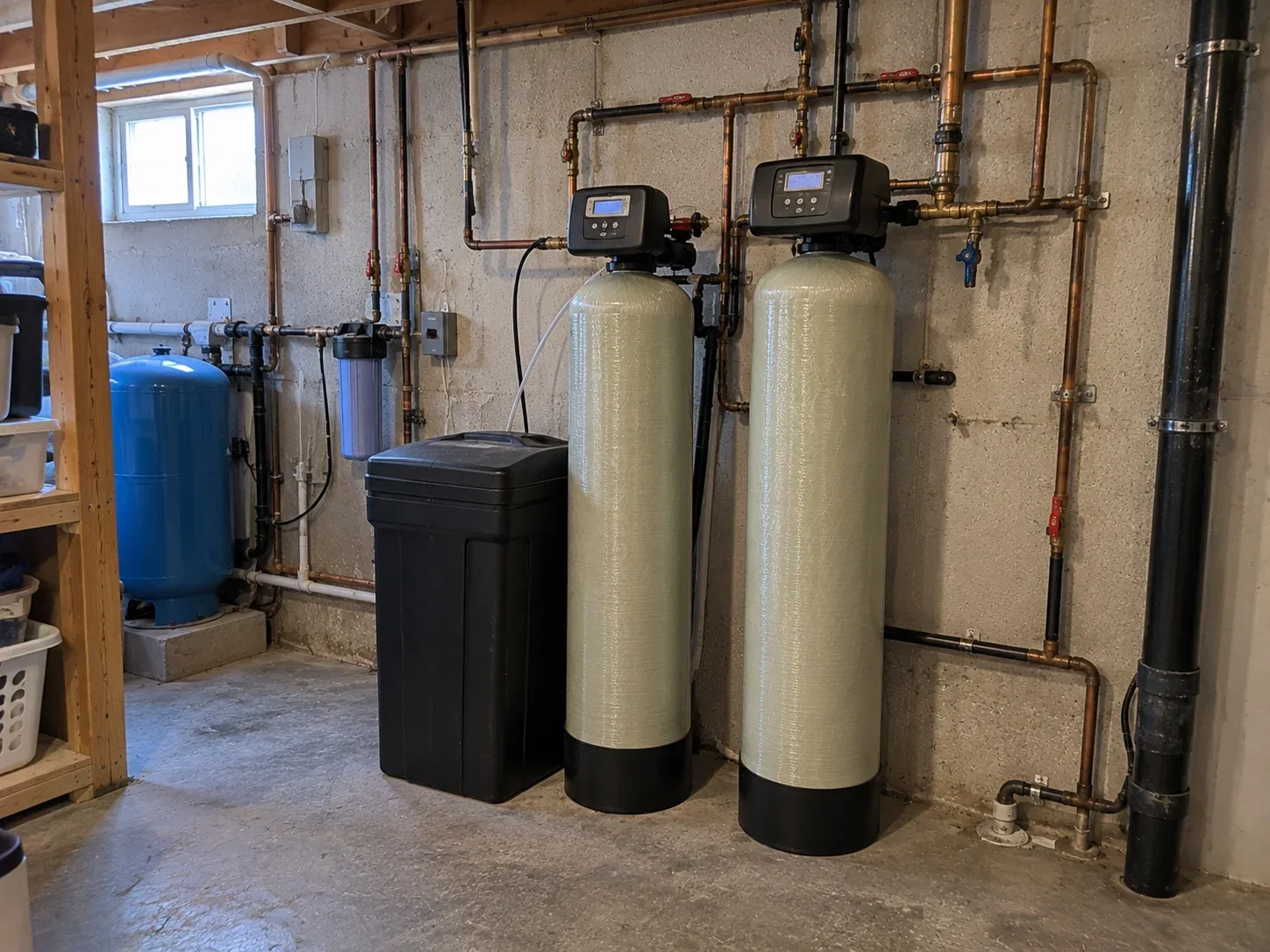 Residential private well water treatment system with water softener, iron filter and brine tank in Chatham-Kent basement